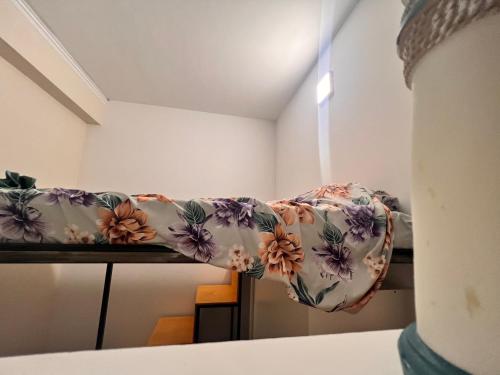 a couch with a blanket on it in a room at Pompeano House in Mazara del Vallo