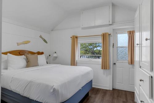 a bedroom with a large bed and a window at White Point Beach Resort in Summerville Centre