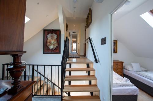 a staircase leading to a living room with a couch at Villa Vintage Room B 107 in Tomášikovo