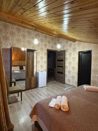 a bedroom with a bed with two towels on it at Guest House Tamta in Stepantsminda