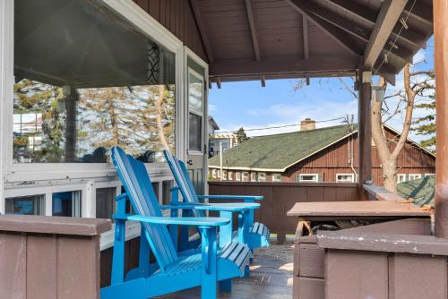 two blue chairs sitting on the porch of a house at White Point Beach Resort in Summerville Centre
