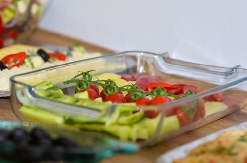 a glass container filled with vegetables on a table at Vila Intre Lacuri in Sovata