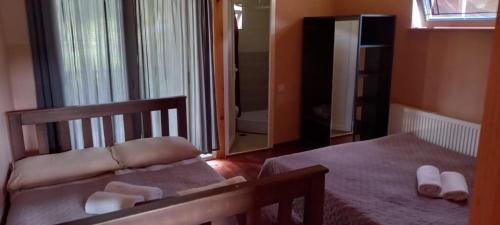 a bedroom with a bed and a mirror at Apartment of mestia in Mestia