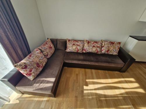 a brown couch with pillows on it in a room at HOLIDAY NEST Family Guest House 80m2 - Mysigt gästhus med två sovrum i Höör in Höör