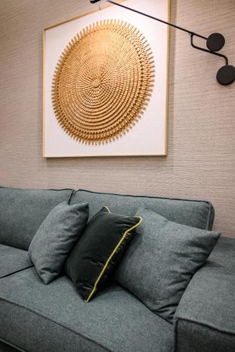 a wall with a picture and a couch with pillows at STF Luxury Suites in Nafplio