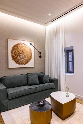 a living room with a couch and a coffee table at STF Luxury Suites in Nafplio