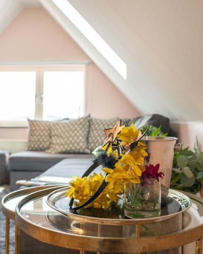 a glass table with flowers on it in a living room at Waxholms Hotell in Vaxholm
