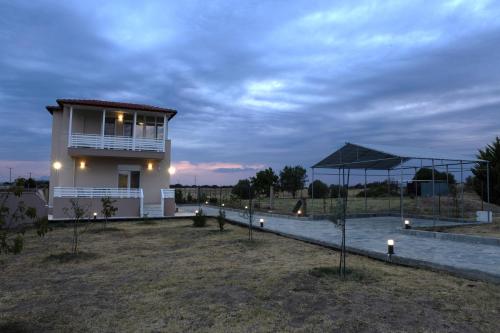 a small house with lights on the side of it at Star View Home in Alexandroupoli