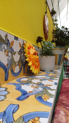 a table with a colorful table cloth with a sun figure on it at amazing sea cottage "Sleep To The Sound Of The Surf" casetta al mare in Ospedaletti