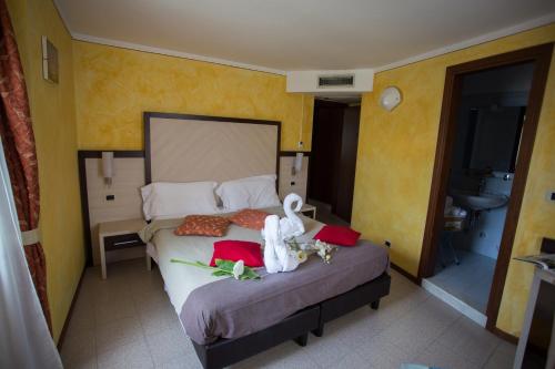 a bedroom with a bed with two swans on it at Locanda San Marco in Torri del Benaco