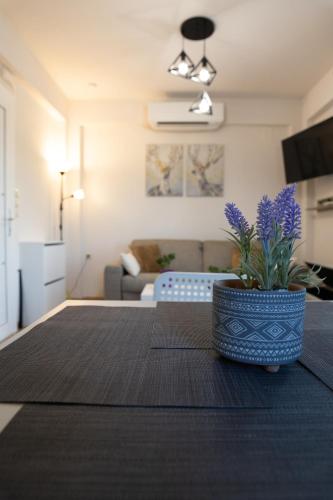a living room with a table with a plant on it at Star View Home in Alexandroupoli