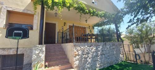 a house with stairs and a fence in front of it at Casa Rural Rincones de Albares in Albares