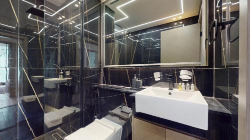 a bathroom with a white sink and a mirror at Vacationer Holiday Homes I Stylish 2 Bed l Balcony with Pool Views l JVC in Dubai