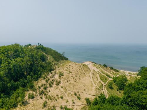 an aerial view of a hill near the ocean at Lake Effect Lodge 3 Minutes From Laketown Beach! in Holland