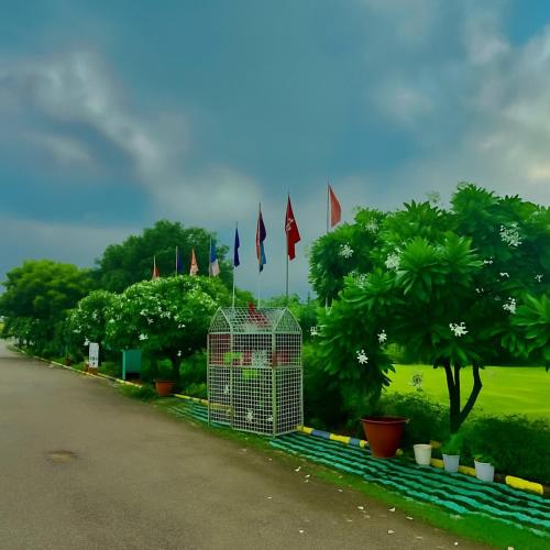 a row of flags on the side of a road at Tata Vista Resort, Vrindavan - #big swimming pool #luxury rooms #gardens #playing zone #away from city hustle # BY ELEGANCE GROUP# in Vrindāvan