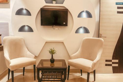 a waiting room with chairs and a tv at Tata Vista Resort, Vrindavan - #big swimming pool #luxury rooms #gardens #playing zone #away from city hustle # BY ELEGANCE GROUP# in Vrindāvan