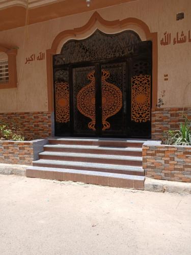a entrance to a building with a black door at Essa Apartment in Safaga 
