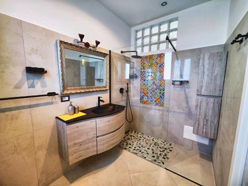 a bathroom with a sink and a mirror and a shower at Villa Mansi Amalfi Coast- Sea View Free Park in Atrani