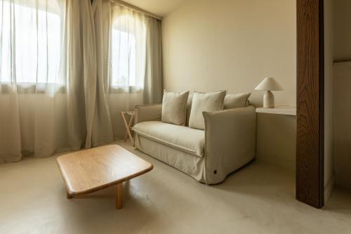 a living room with a couch and a table at Les Clarisses Boutique Hotel in Vic