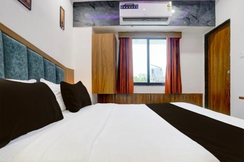 Ένα ή περισσότερα κρεβάτια σε δωμάτιο στο Super Hotel O Rion Inn
