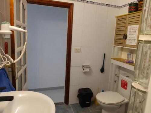a bathroom with a white toilet and a sink at Vistas al mar 2 in Tías