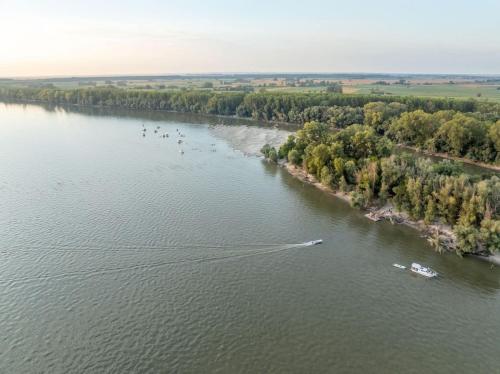 an aerial view of a boat on a river at APARTMANI JERKOVIĆ - DUNAV 1 - Premium in Vukovar