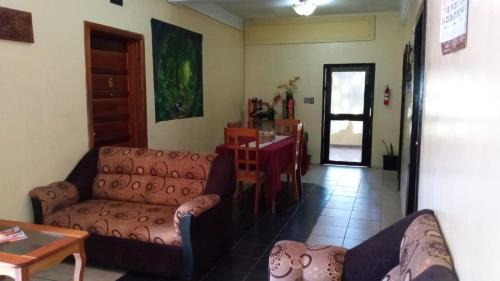 a living room with two couches and a table at Maxroomz in San Ignacio