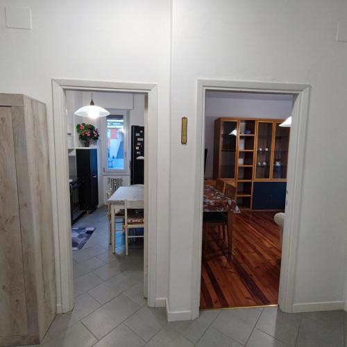 a kitchen and a dining room with a table at Appartamento Stella in Sondrio