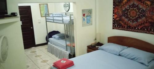 a bedroom with a bed and a bunk bed at Maxroomz in San Ignacio