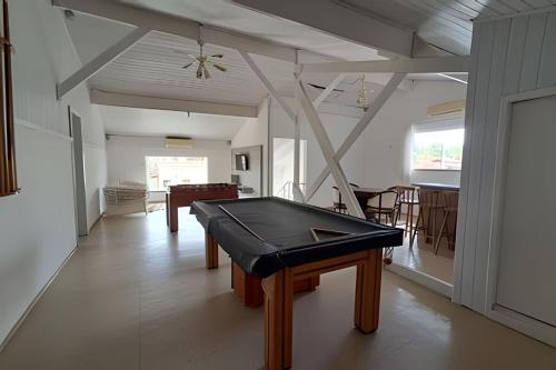 a living room with a ping pong table in it at Casa na Morada da Praia - Q83 in Bertioga