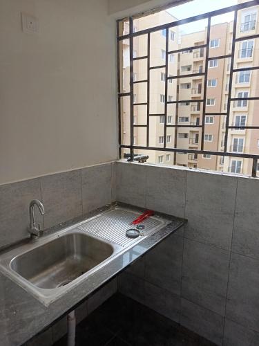 a sink in a room with a window at Skyview 3 bhk Retreat in Bayappanhalli
