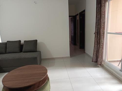 a living room with a couch and a table at Skyview 3 bhk Retreat in Bayappanhalli