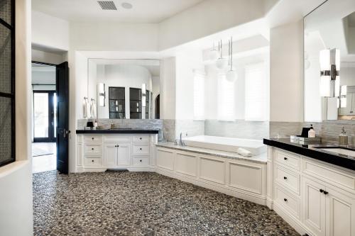 a white bathroom with a tub and a sink at Casa Consola in Scottsdale