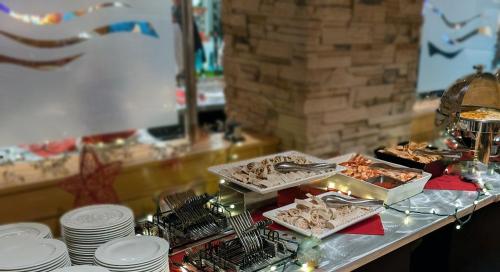 a buffet with plates and food on a table at Radisson Hotel La Crosse in La Crosse
