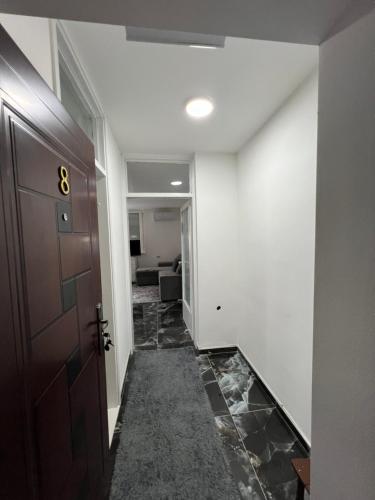a hallway with a door and a tile floor at Apartman Boža 1 in Kuršumlija