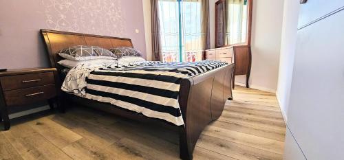 a bedroom with a bed and a wooden floor at See Of Galilee 510 in Tiberias
