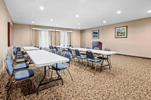 a conference room with tables and chairs and a podium at Comfort Inn & Suites Oxford South in Oxford