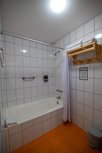 a bathroom with a bath tub in a room at San Sebastian Hotel Boutique in Huaraz