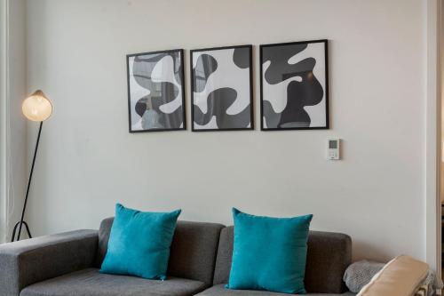 a living room with a couch with blue pillows at Chic 4-Bedroom with Skyline Views & Amenities in Chicago