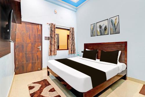 a bedroom with a large bed and a television at Hotel O Prakash Residency in Tapovan