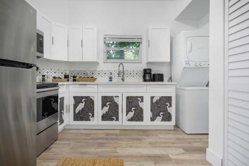 a kitchen with white cabinets and a sink at Havana Oh Na Na Unit C in Miami