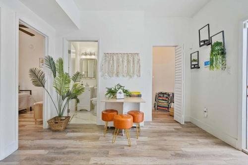 a living room with a table and two orange chairs at Havana Oh Na Na Unit C in Miami