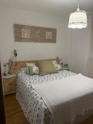 a bedroom with a bed with a white bedspread at Dulce y sereno piso en Oviedo in Oviedo