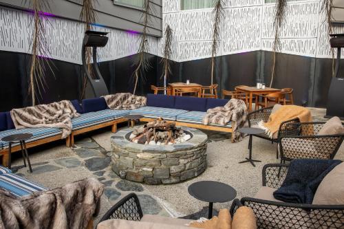 a living room with a couch and a fire pit at Holiday Inn Express & Suites Queenstown by IHG in Queenstown