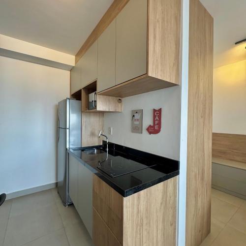 a kitchen with a sink and a refrigerator at Apartamentos Prime - Jardins in Sao Paulo