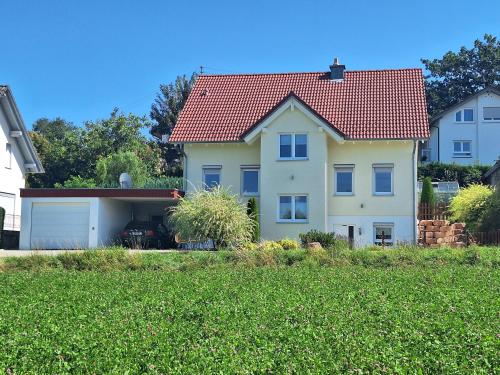 a large white house with a red roof at Ferienwohnung Dressler in Wolfegg
