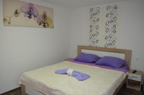 a bedroom with a bed with purple pillows at Apartment Igor in Baška