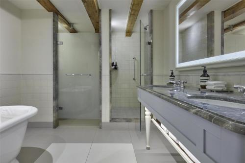 a bathroom with a sink and a shower at Waldorf Astoria Amsterdam in Amsterdam