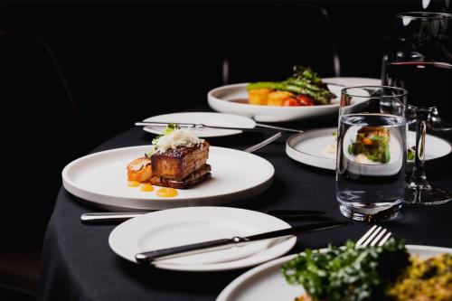 a table with plates of food on a black table at Parmelia Hilton Perth in Perth