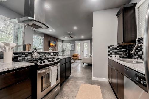 a kitchen with black and white counter tops at Austin Retreat Hot Tub and Relaxing Patio in Austin